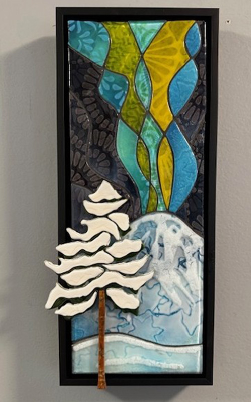 White Pine tree in front of a mountain with waves of color streaming from the top